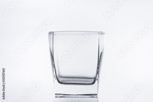 Empty glass glass for water or alcohol on a white background. Close-up photo