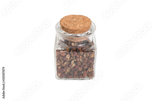 sichuan pepper in a glass jar isolated on white background. spices and food ingredients. spices and food ingredients