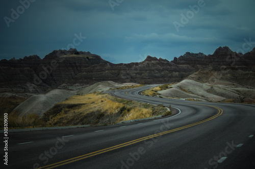 Empty Road Winding Through Badlands National Park