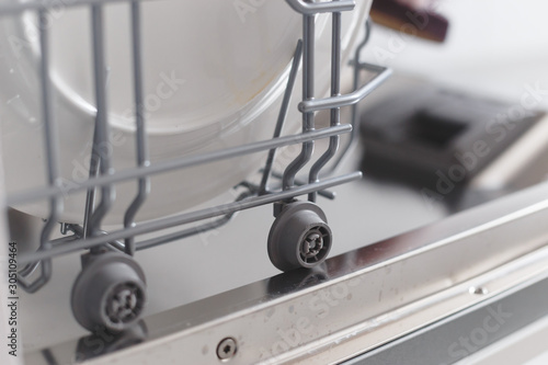 Close-up view of extendable shelf on wheels in the dishwasher.