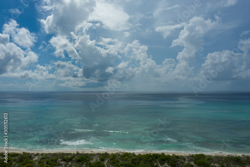 Drone view of a coastal area, ocean and cloud formations over Grand Turk in Caribbean