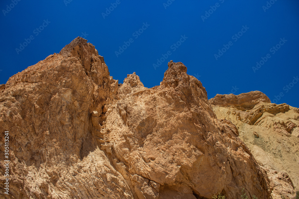 sand stone desert canyon dry rocks geological nature scenic background with blue sky 