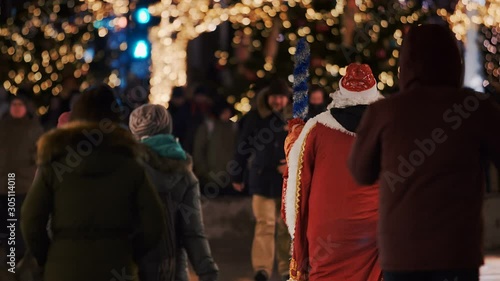 New Year's city with luminous colorful trees and with Santa Claus going to give gifts to children. Moscow, Russia