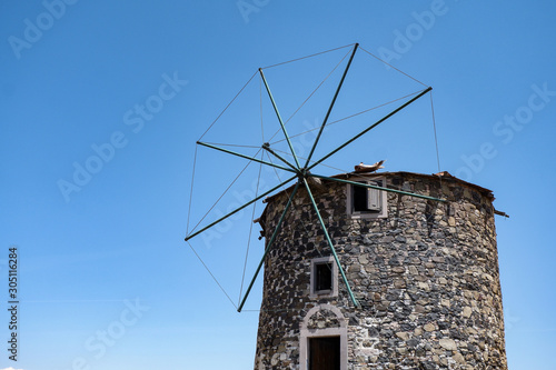Historic windmill on a clear summer day, blue sky, stone