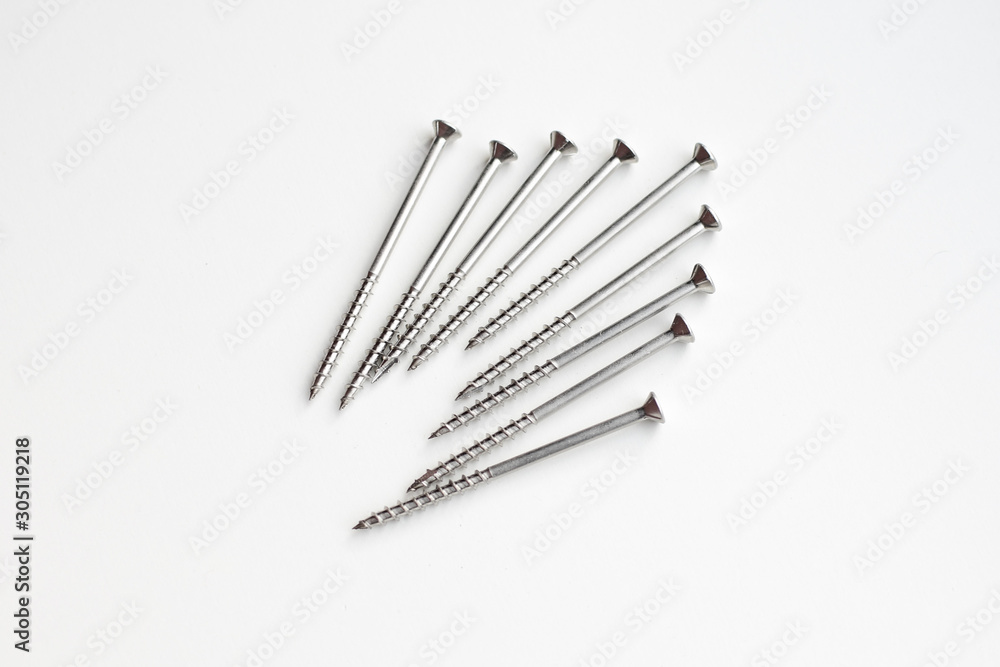The screws are on a white surface. The screws are on a white surface.