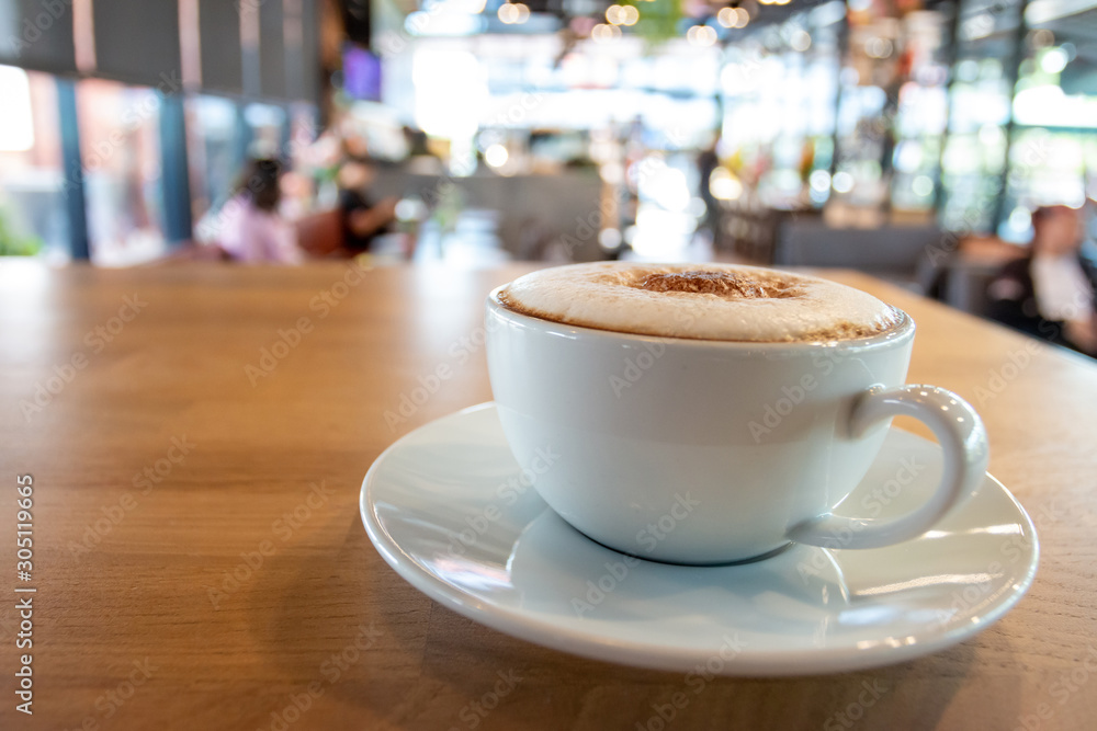 A cup of fragrant cappuccino coffee. In the morning in the cafe, coffee makes the body refreshed. A cup of fragrant cappuccino coffee. In the morning in the cafe, coffee makes the body refreshed.