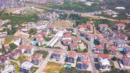 Aerial panoramic view of summer city with luxury houses, swimming pools, hotels and green trees. Clip. Flying above the south city.