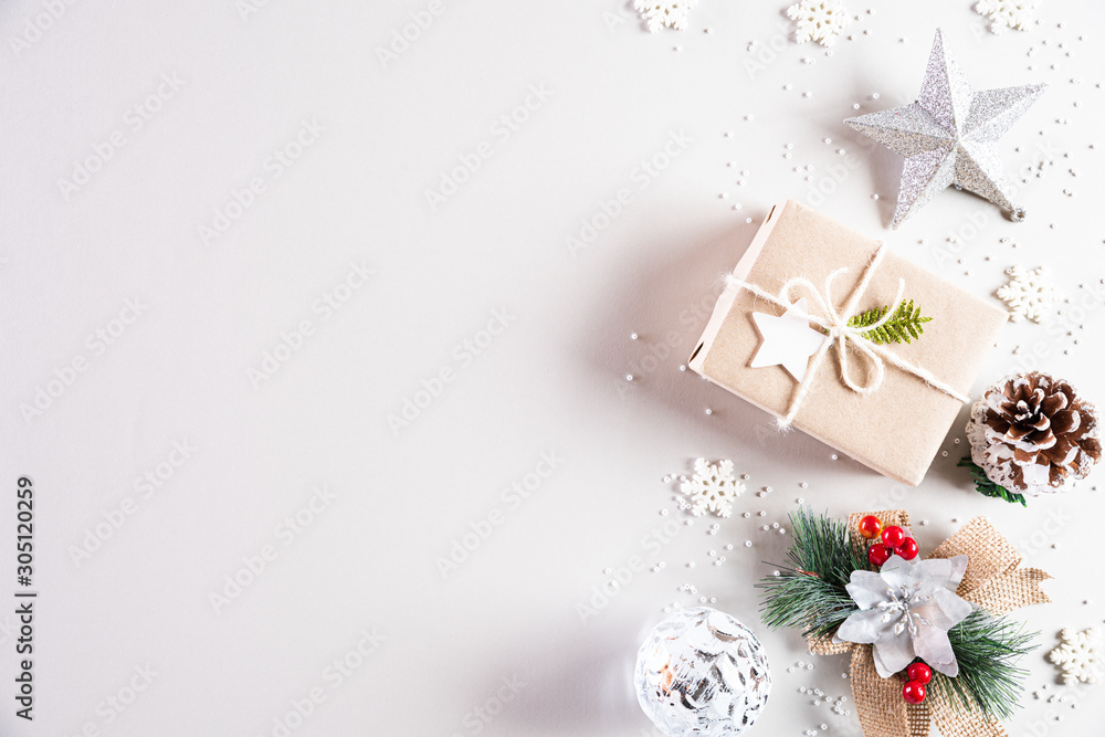 Christmas holidays composition Top view of gift box with Christmas tree decoration and red berries on white background with copy space for text. Christmas holidays composition Top view of gift box with Christmas tree decoration and red berries on white background with copy space for text.