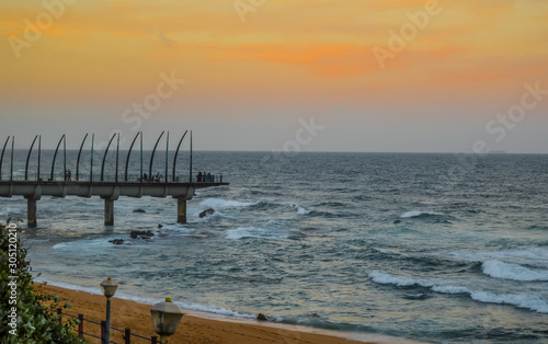 Beautiful Umhlanga Promenade Pier a whalebone made pier in Kwazulu Natal Durban North South Africa during sunset photo