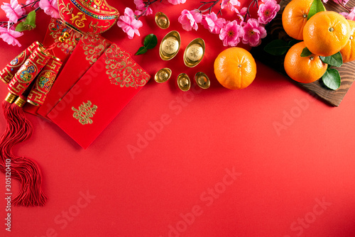 Chinese new year festival decorations pow or red packet  orange and gold ingots or golden lump on a red background. Chinese characters FU in the article refer to fortune good luck  wealth  money flow.