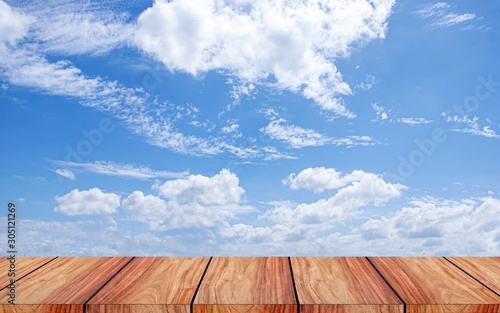 A blank wooden table and wooden floor on a beautiful sky background.
