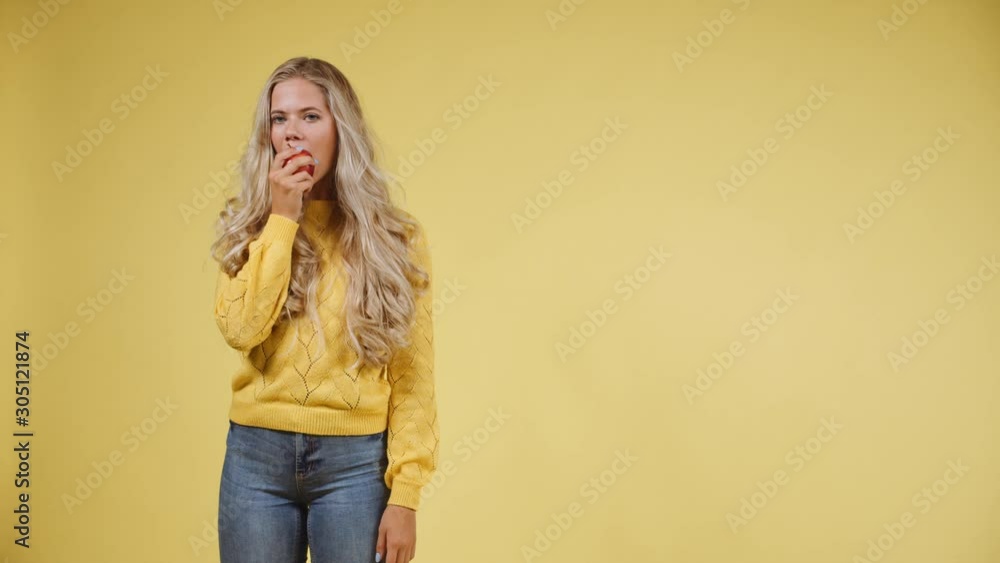 Hungry Woman with Long Blonde Hair Eating an Apple with a Smile on Her Face Hungry Woman with Long Blonde Hair Eating an Apple with a Smile on Her Face