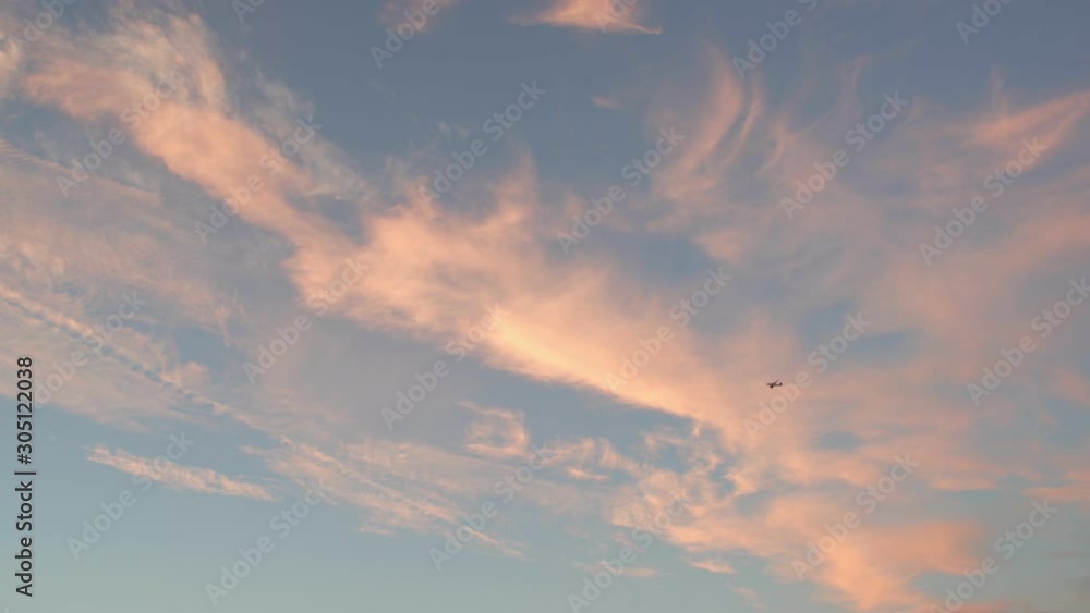 Sunset view of an airplane flying with red clouds Sunset view of an airplane flying with red clouds