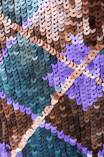 Fabric with sequins and sequins of bright colors. Fashion glitter fabric, sequins. Shiny surface