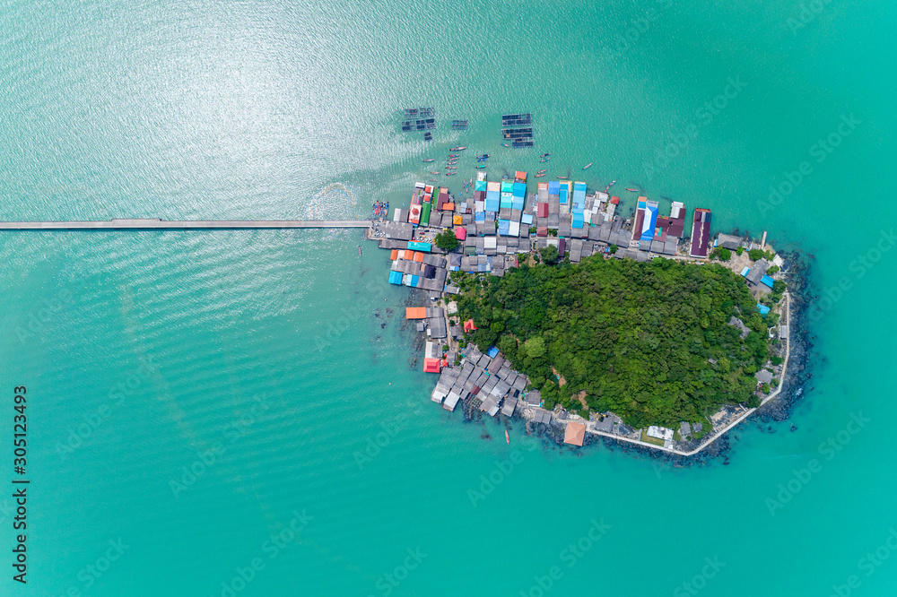Aerial view top down of small island in tropical sea with small bridge to the island located koh rat suratthani Thailand