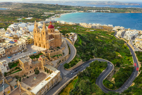 Aerial view of The Parish Church in Melieha city and road. Blue sky, sea, day. Winter. Malta island photo