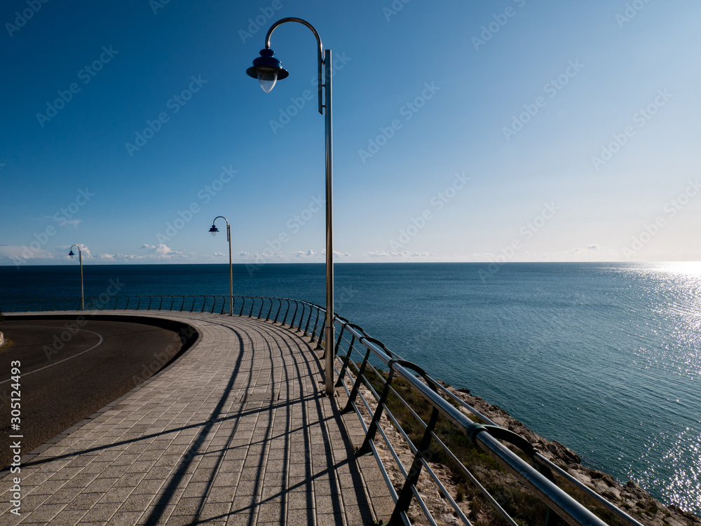 road by the sea with shadows and geometric shapes