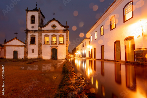 Church in flooded street at night in the historical center of Paraty, Rio de Janeiro, Brazil, World Heritage. Paraty is a preserved Portuguese colonial and Brazilian imperial city. photo