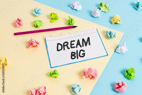 Word writing text Dream Big. Business photo showcasing seeking purpose for your life and becoming fulfilled in process Colored crumpled papers empty reminder blue yellow background clothespin © Artur