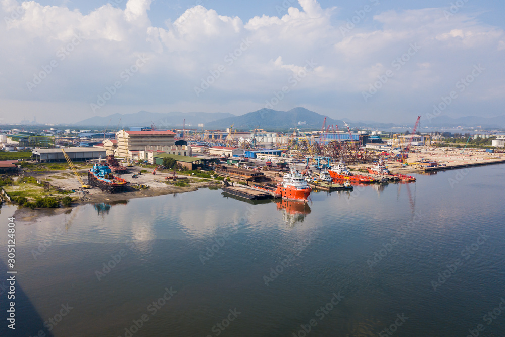Aerial view of shipyard nearby the main river where the vessels and boats docking.