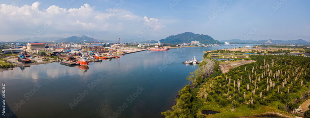 Aerial view of shipyard nearby the main river where the vessels and boats docking.