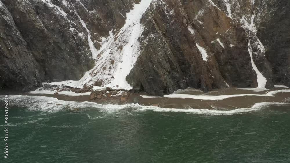 Shooting of rocks and the seashore when it is snowing from the drone. Shooting of rocks and the seashore when it is snowing from the drone.