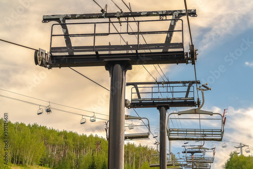 Cloudy summer day landscape at a ski resort with chairlifts and trails