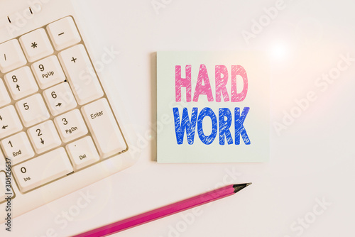 Handwriting text Hard Work. Conceptual photo always putting a lot of effort and care into work or endurance White pc keyboard with empty note paper and pencil above white background