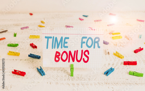 Handwriting text writing Time For Bonus. Conceptual photo a sum of money added to a demonstrating s is wages as a reward Green clothespin white wood background colored paper reminder office supply