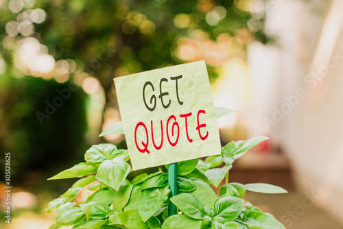 Text sign showing Get Quote. Business photo text the most recent price to which a buyer and seller agreed Plain empty paper attached to a stick and placed in the green leafy plants © Artur