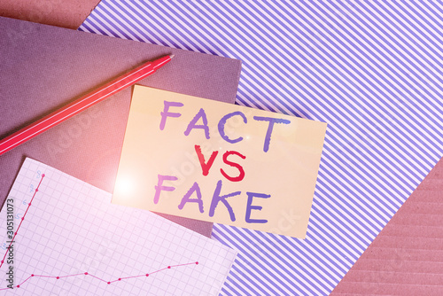 Conceptual hand writing showing Fact Vs Fake. Concept meaning Rivalry or products or information originaly made or imitation Striped paperboard cardboard office study supplies chart photo