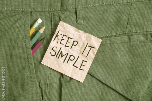 Text sign showing Keep It Simple. Business photo text Remain in the simple place or position not complicated Writing equipment and pink note paper inside pocket of man work trousers