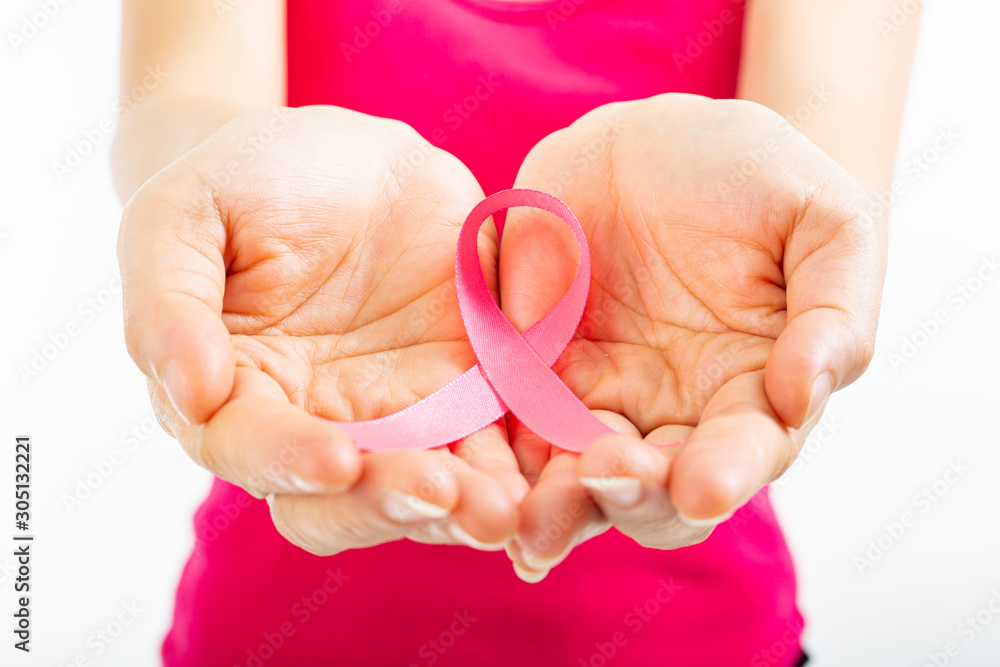 Holding pink ribbon cancer concept for show symbol.