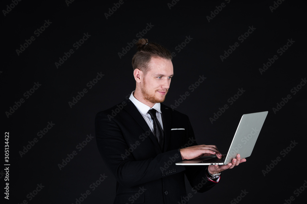 Confident businessman in black suit using technology on hand Confident businessman in black suit using technology on hand