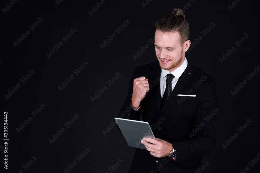 Confident businessman in black suit using technology on hand Confident businessman in black suit using technology on hand