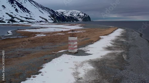 Old beacon on the sea spit. Place of shooting northerly coast of the Bering Sea, Chukchi region, Russia.