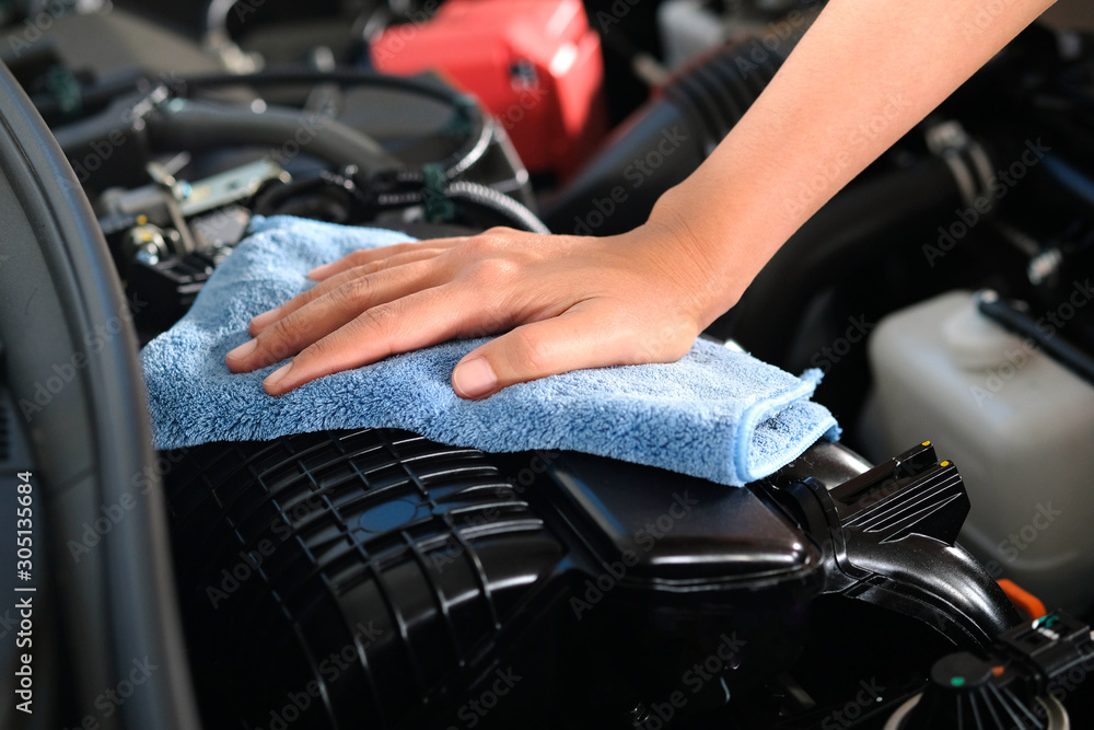 hand of a man holding a blue cloth caring, maintenance car and cleaning And engine car room hand of a man holding a blue cloth caring, maintenance car and cleaning And engine car room