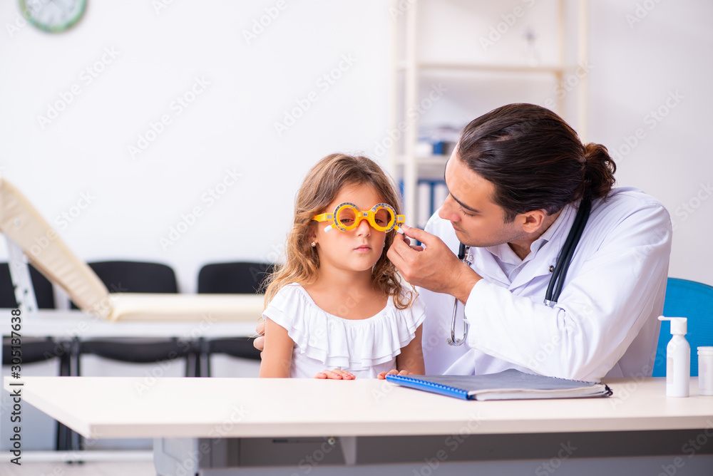 Young doctor pediatrician with small girl Young doctor pediatrician with small girl