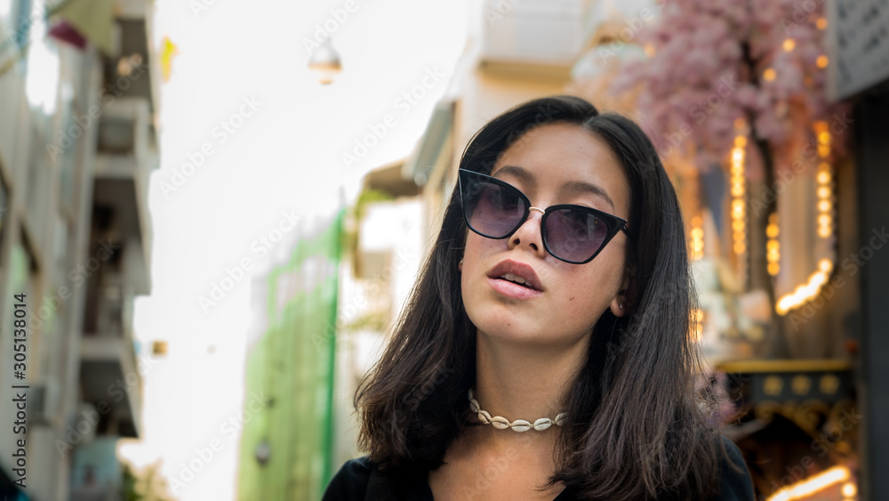 Portrait young Asian teen with sunglasses posing for camera