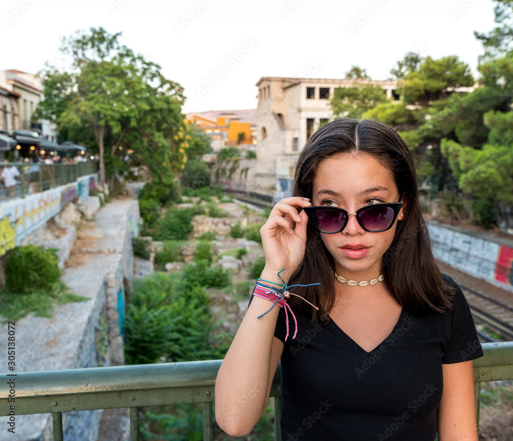 Portrait young Asian teen with sunglasses posing for camera