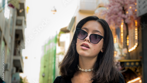 Portrait young Asian teen with sunglasses posing for camera