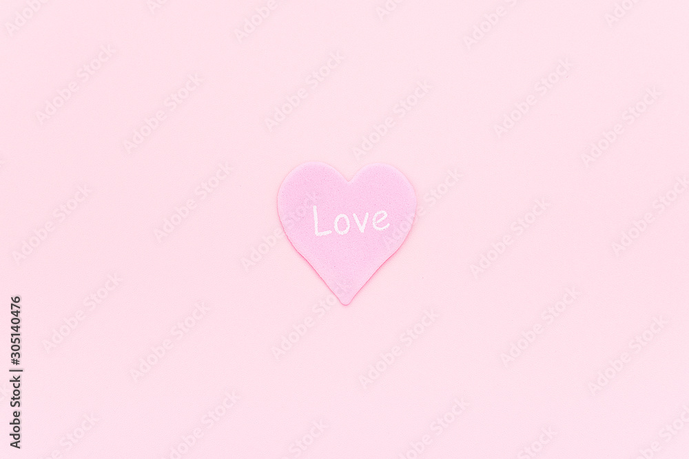 Pink heart with text LOVE on pink background, central composition, minimal style. Concept declaration of love, love confession. Valentines day, Mothers day, Womens day, wedding card