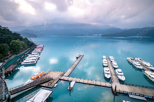 Sun Moon Lake, Taiwan - March 11, 2019 - Tourist boats docking in peaceful morning at Shuishe Pier, Sun Moon Lake is one of the most popular tourist destination in Taiwan. photo