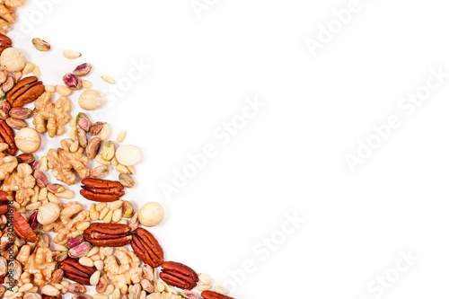 Background of different nuts. Pecan, macadamia, pistachio, pine nuts, walnuts isolated on a white background. Top view.