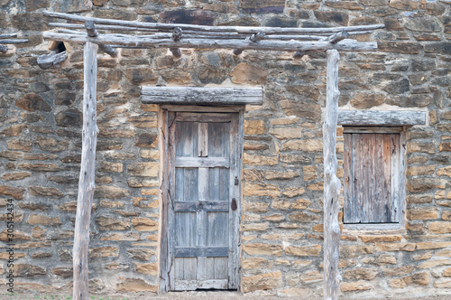 Window and door in old stone wall