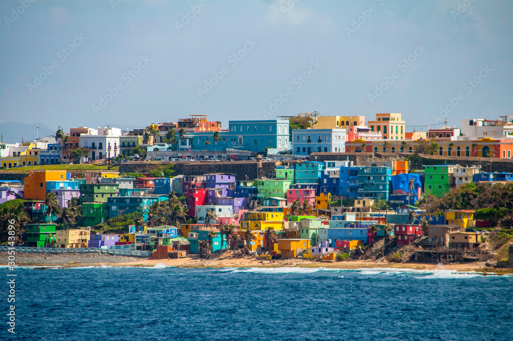 Colorful houses line the hill side overlooking the beach in San Juan, Puerto Rico.