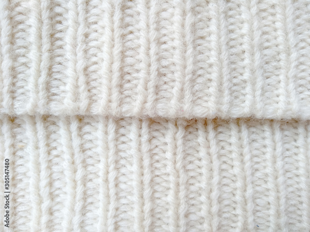 Background of wool yarn for yarn frame. White knitting yarn for handicrafts background. Knitted clothes from wool yarn. Background of wool yarn for yarn frame. White knitting yarn for handicrafts background. Knitted clothes from wool yarn.