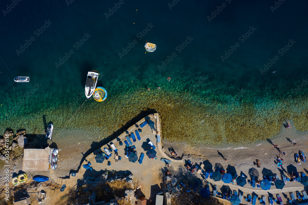 beach of the Greek island of Simi with rocks and clear water view from drone