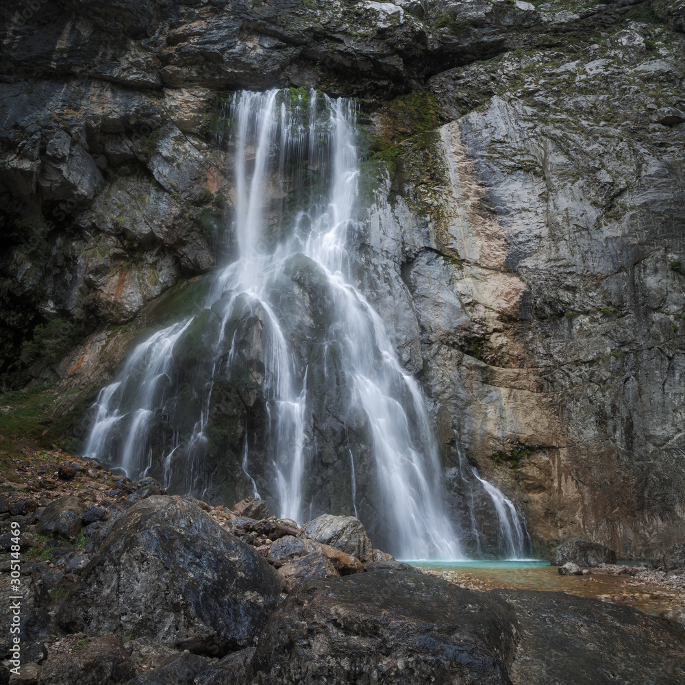 water flows from the waterfall flowing down the rock water flows from the waterfall flowing down the rock