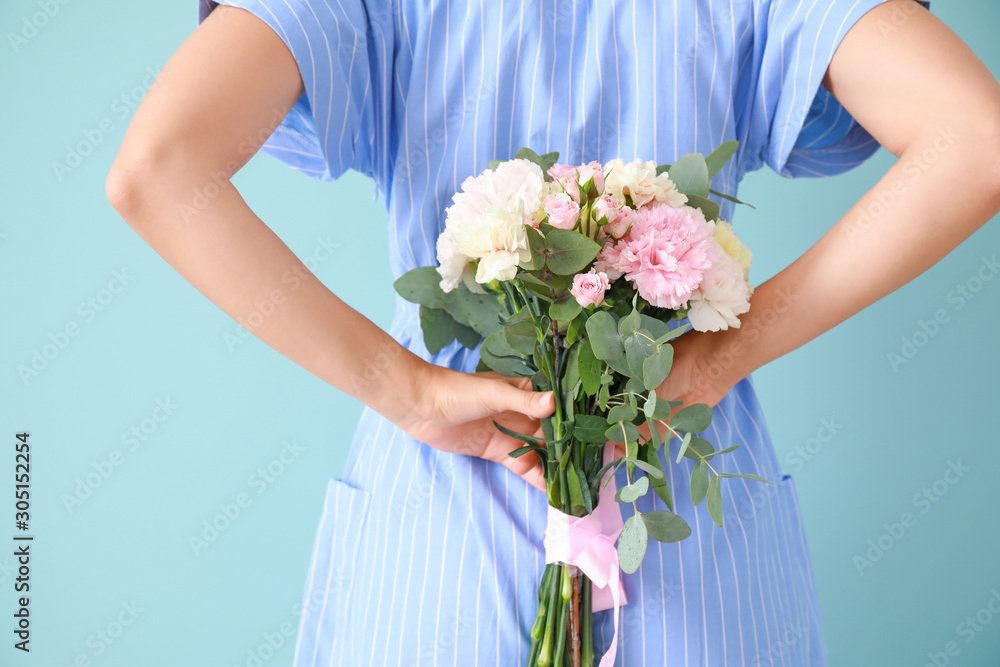 Beautiful young woman with bouquet of carnation flowers on color background Beautiful young woman with bouquet of carnation flowers on color background